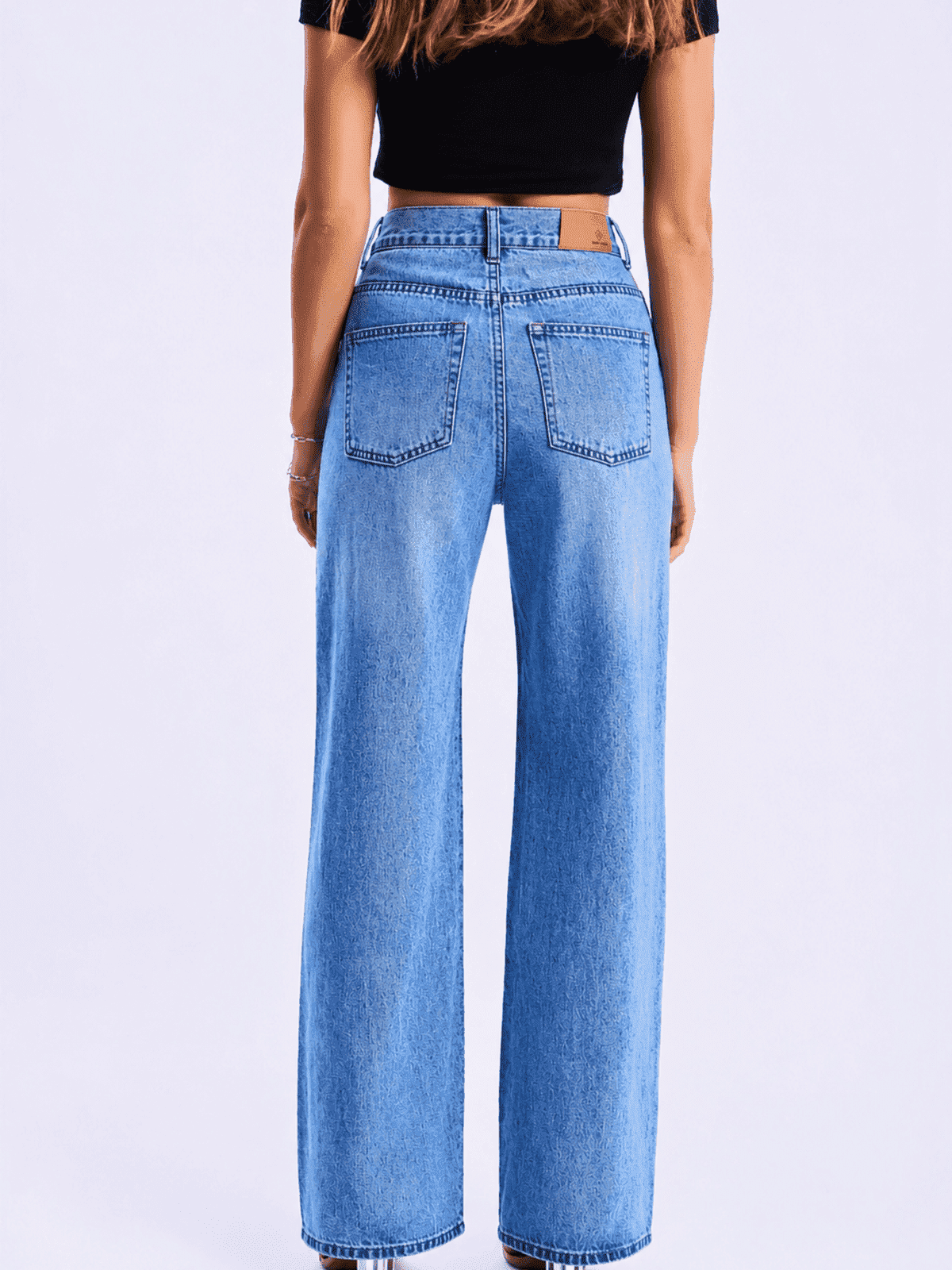 Person wearing blue jeans on a white background
